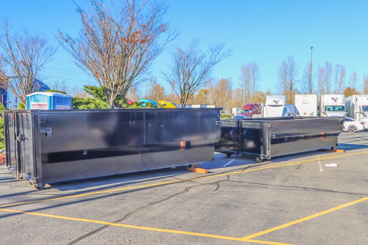 Professional dumpster rental service with roll-off container on residential driveway in Melvindale